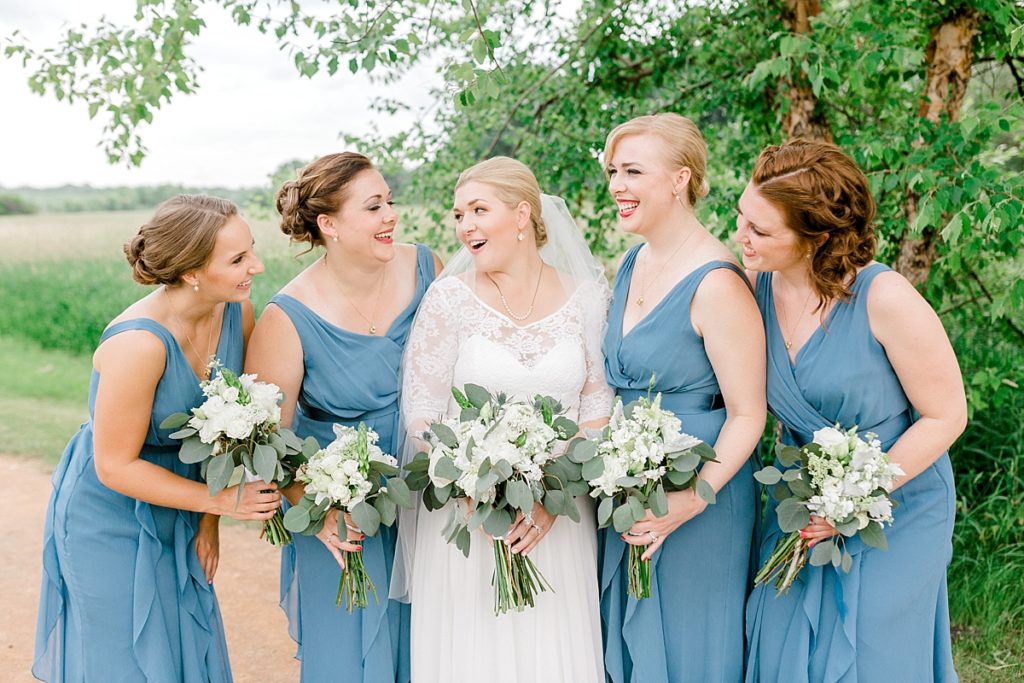 laughing bridal party pictures in steel blue long dresses