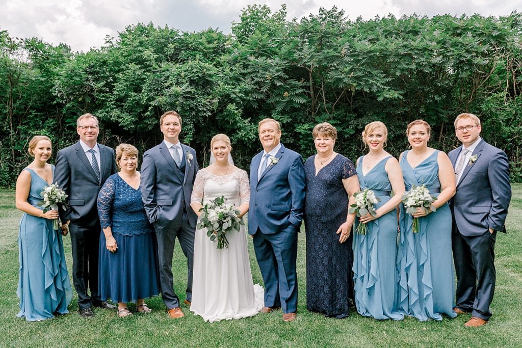Formal family portraits outside on cloudy wedding day
