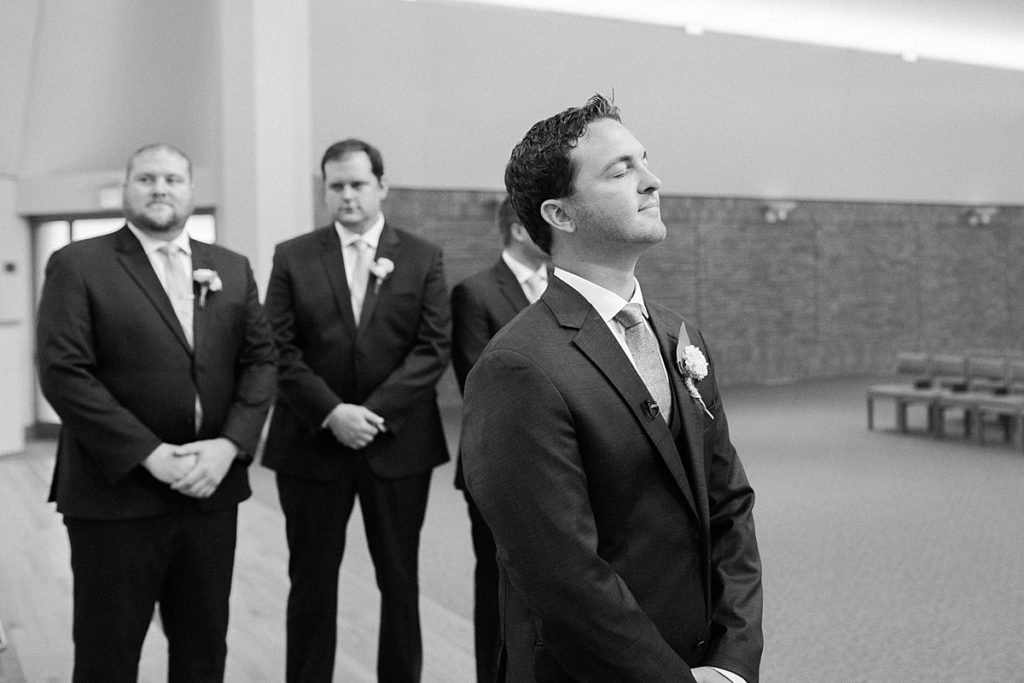 groom waiting for bride to walk down the aisle at St. Andrew Lutheran Church in Minnesota