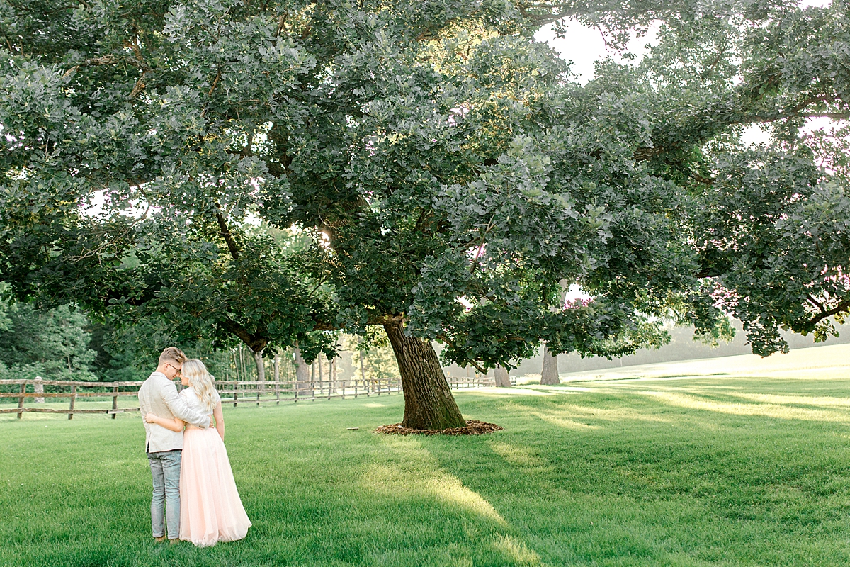 Engagement picture beneath giant oak tree in Rochester, Minnesota
